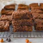 stack of caramel brownies on a cooling rack
