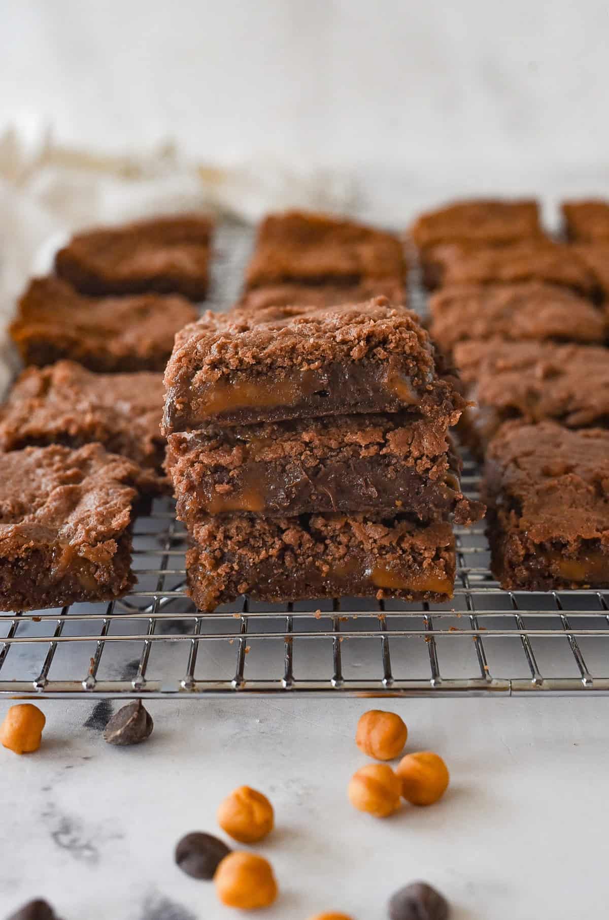 stack of caramel brownies on a cooling rack