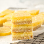 closeup of a stack of lemon cheesecake bars