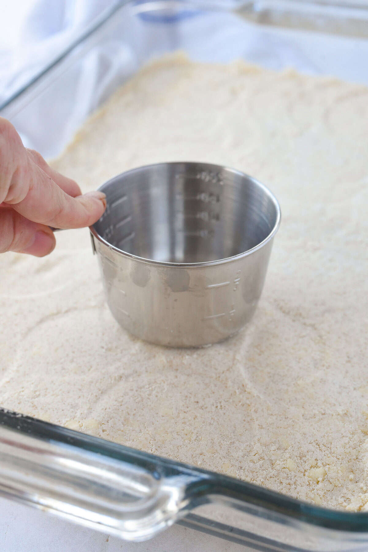 pressing shortbread dough into bottom of pan