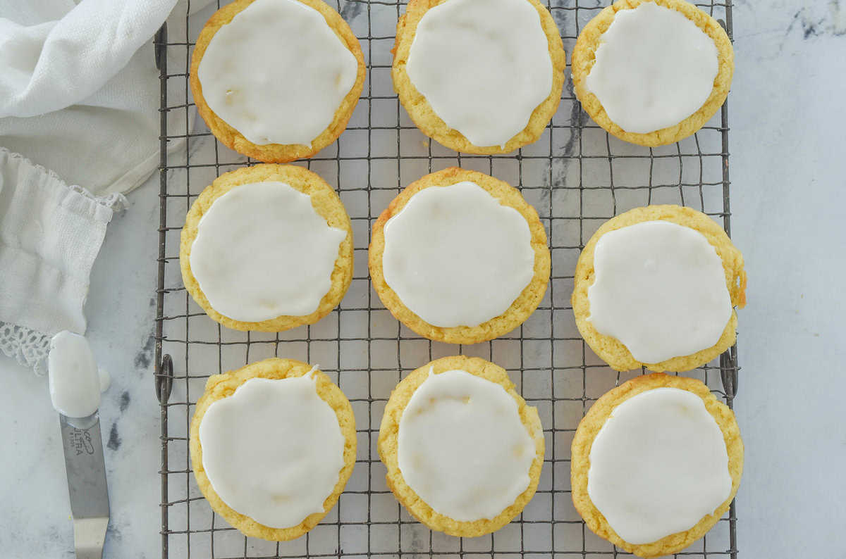 overhead shot of frosted lemon drop cookies on cooling rack
