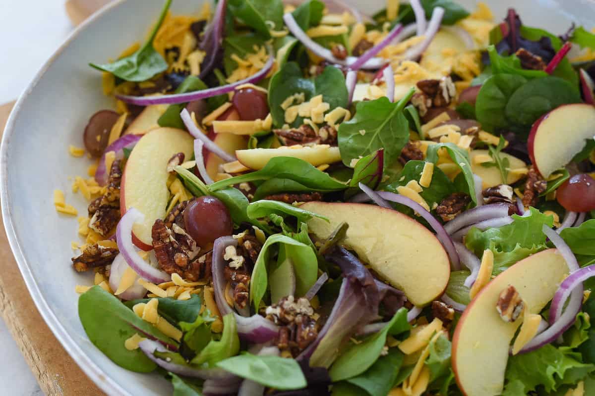 apple pecan salad in a white bowl