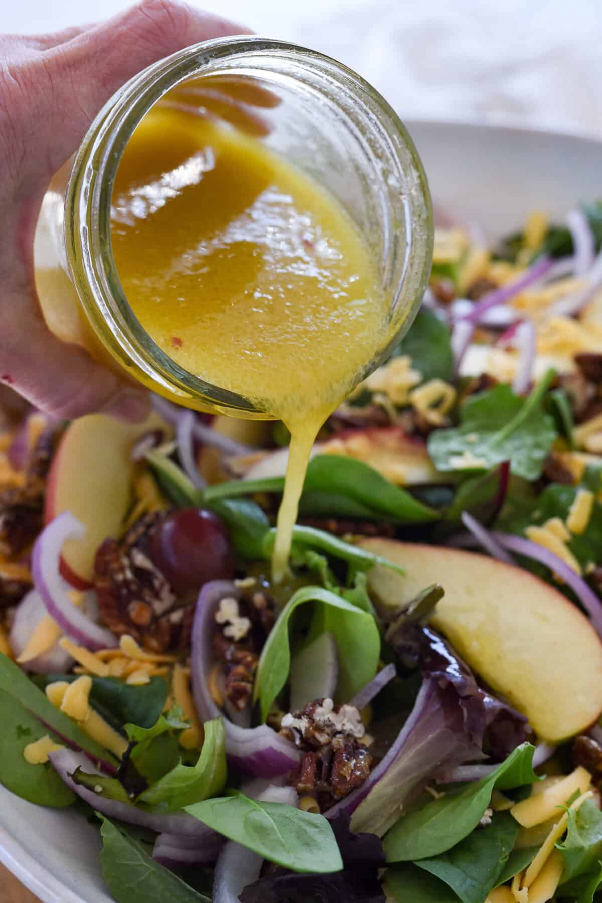 This Apple Pecan Salad is made with crisp sweet apples, grapes, fresh spring lettuce greens and spinach, crunchy toasted pecans and a flavorful mustard vinaigrette. 
