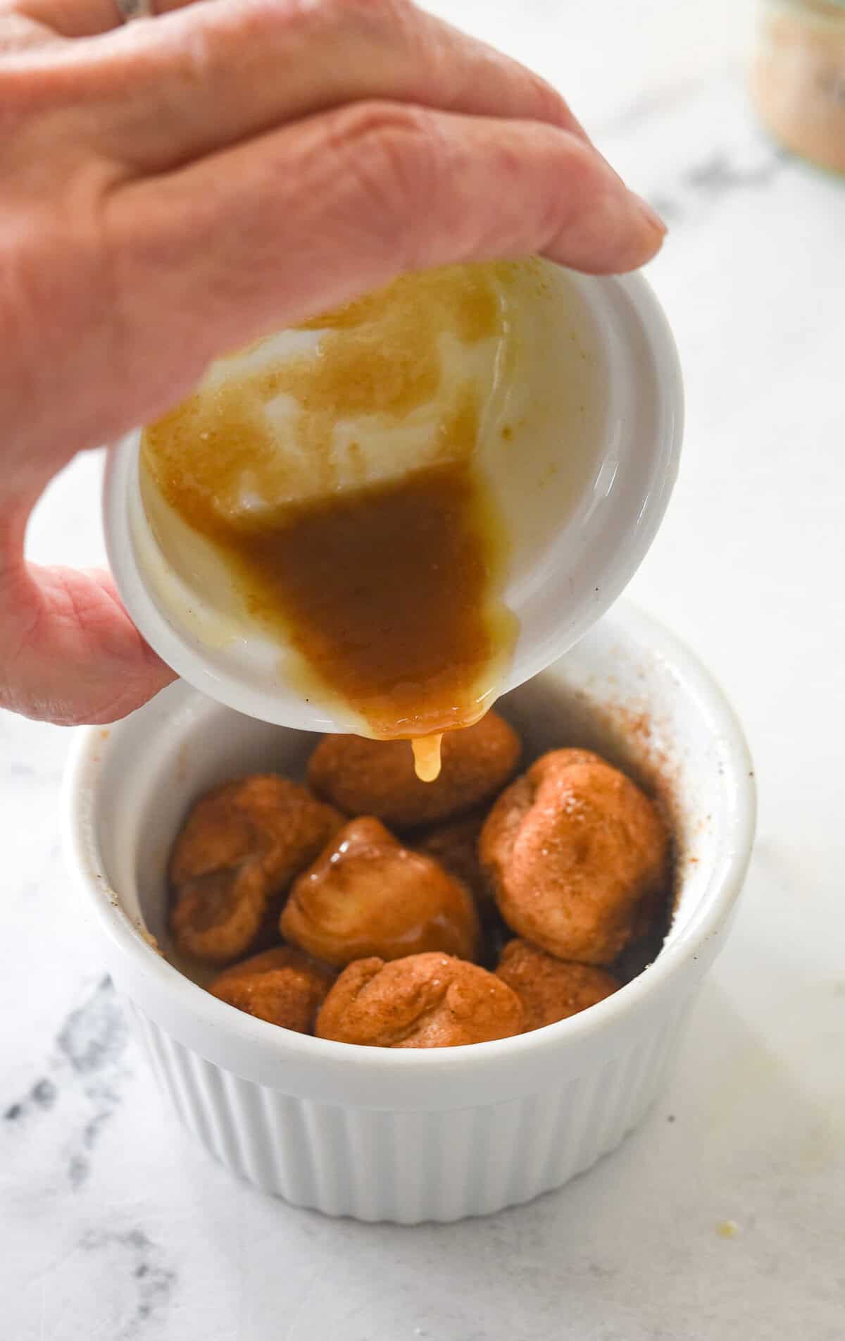 pouring brown sugar and butter over monkey bread