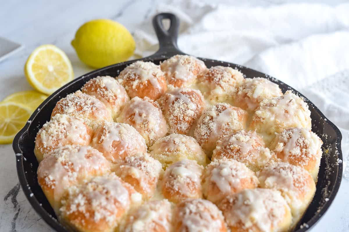 baked lemon pull apart rolls in a black cast iron pan