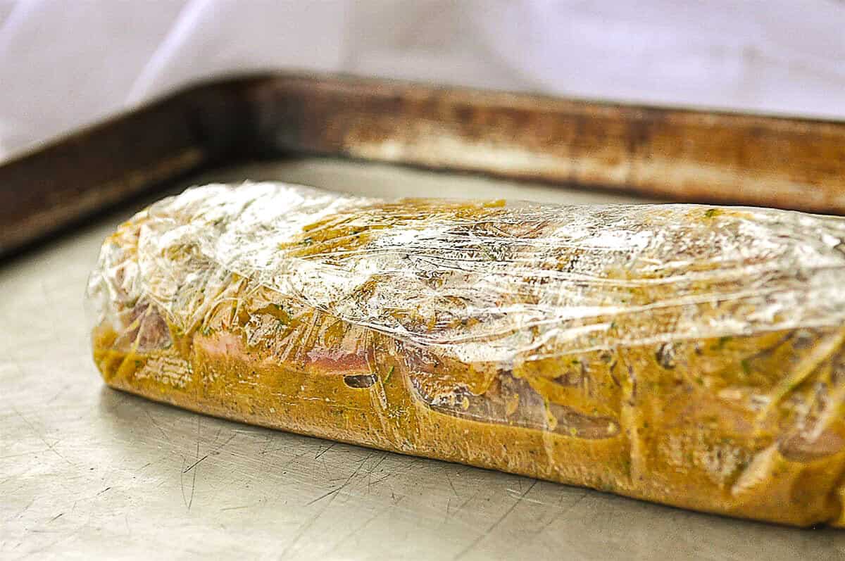 marinading pork tenderloin wrapped in plastic wrap