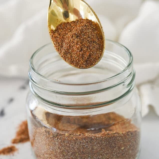 taco seasoning on a spoon and a jar