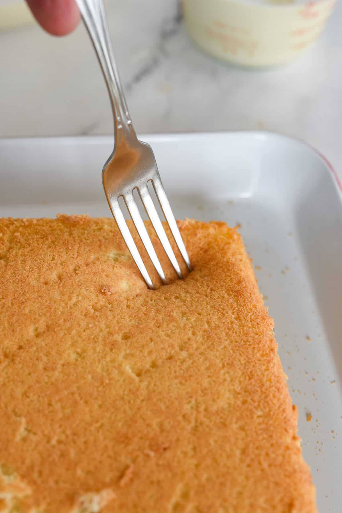 poke holes into cake with a fork