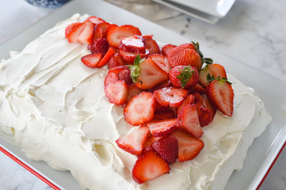 tres leche cake with strawberries on top