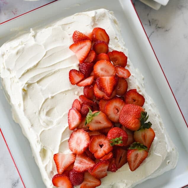 overhead shot of tres leche cake with strawberries on top