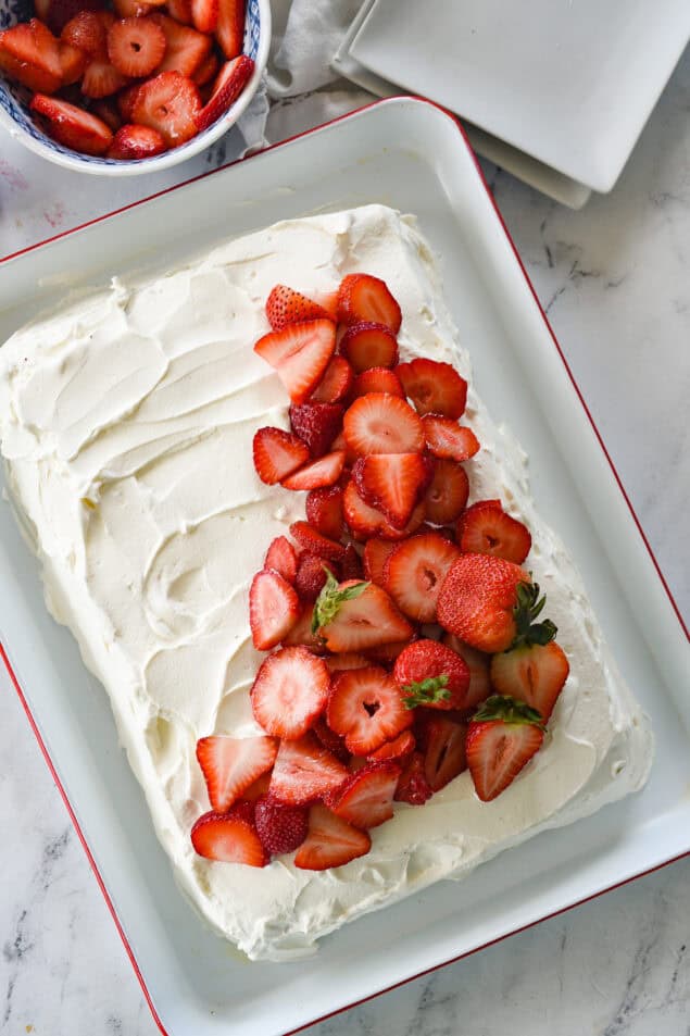 overhead shot of tres leche cake with strawberries on top