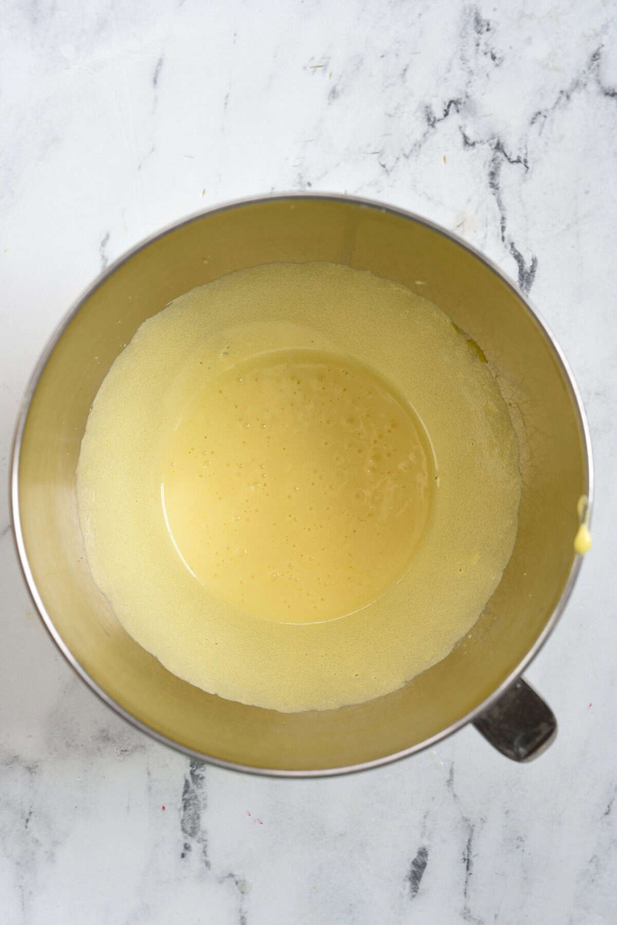 shot of egg yolks and sugar comboined in a bowl