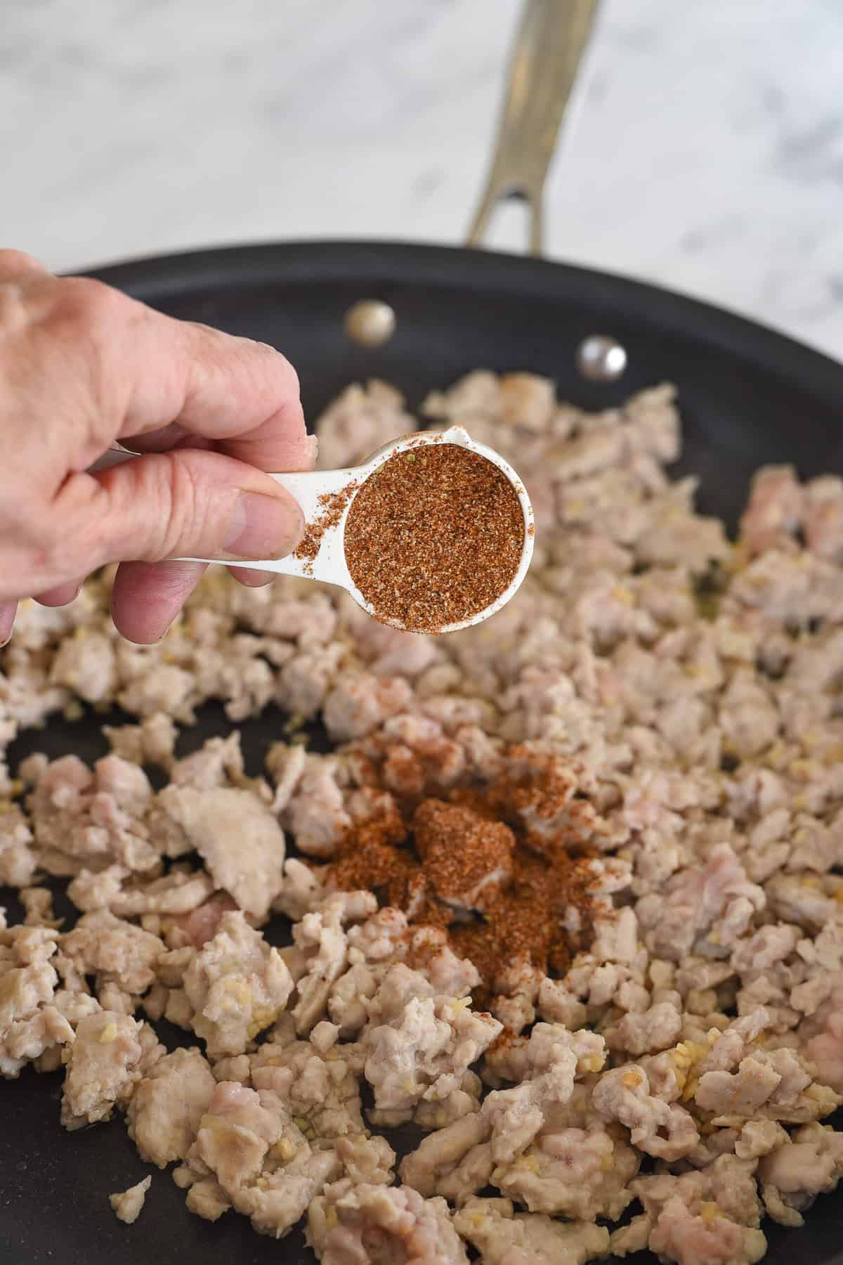 adding taco seasoning to ground chicken