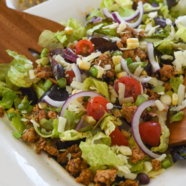 tossed chicken taco salad in white bowl
