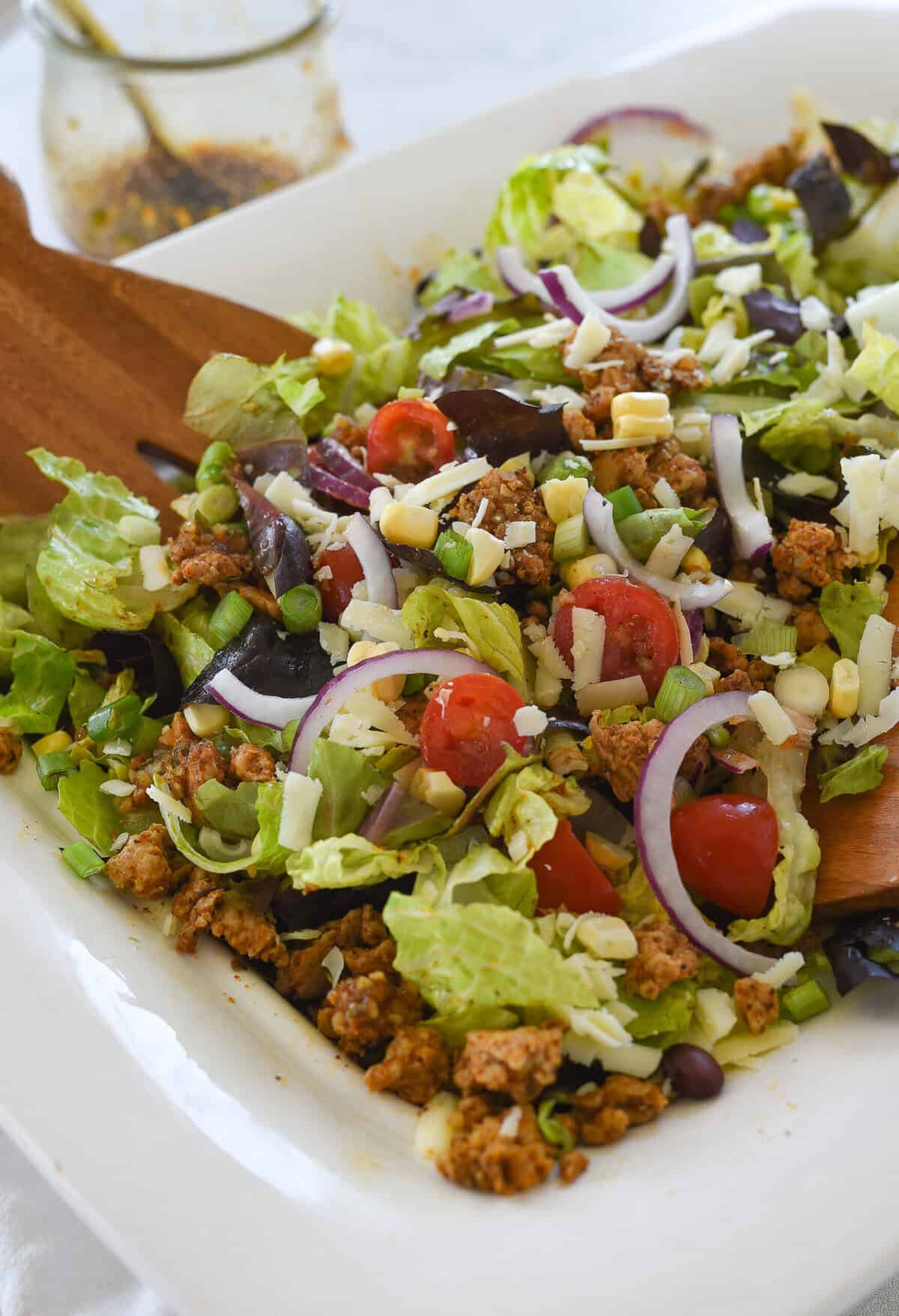tossed chicken taco salad in white bowl