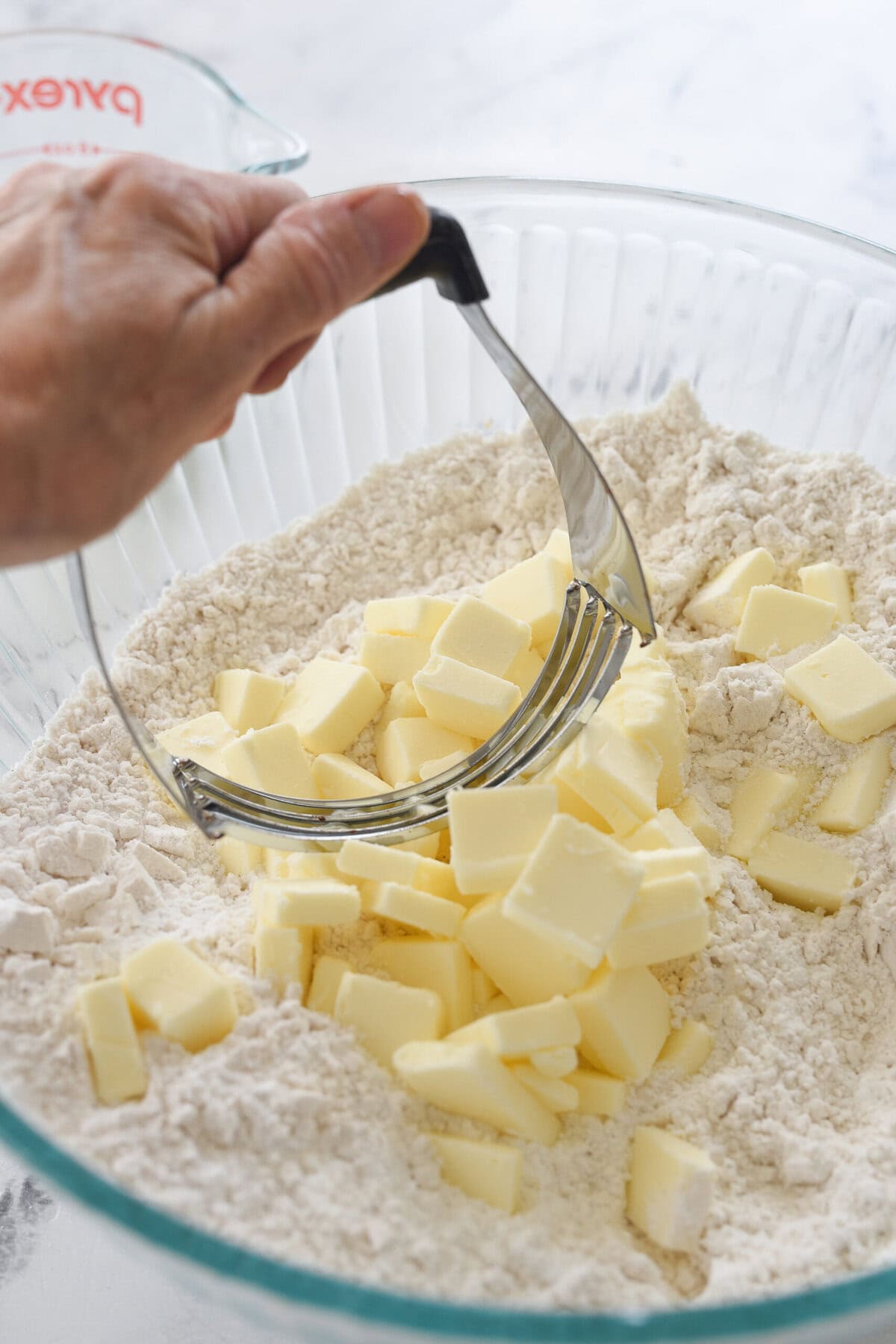 adding butter to flour mixture

