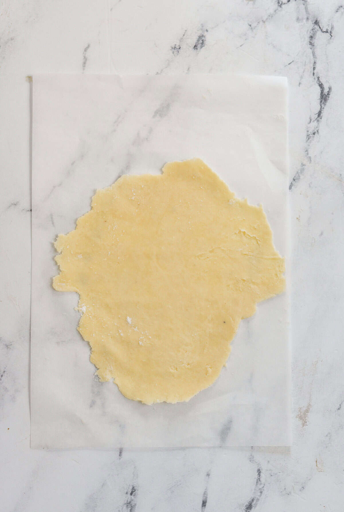 pie crust rolled out on parchment paper
