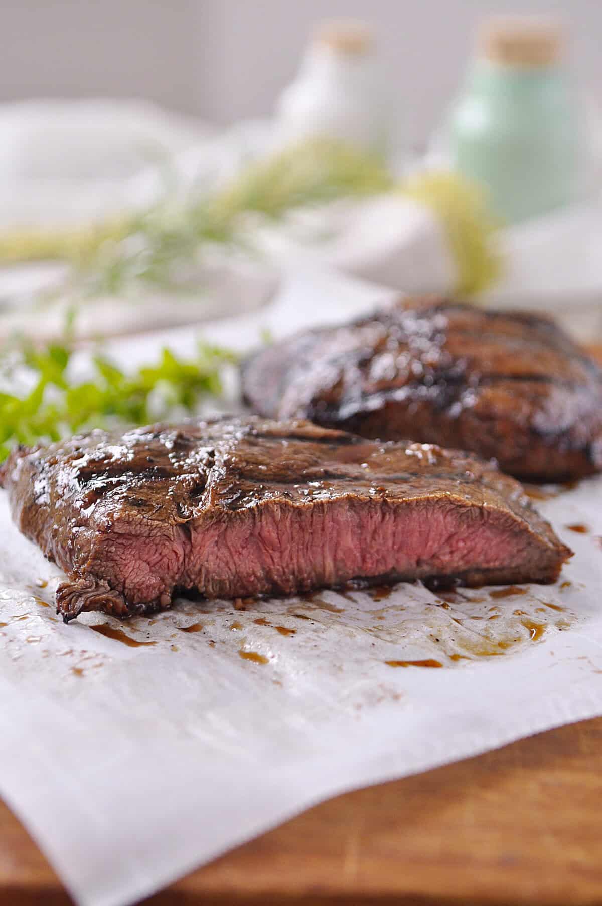 flat iron steak sliced on parchment paper