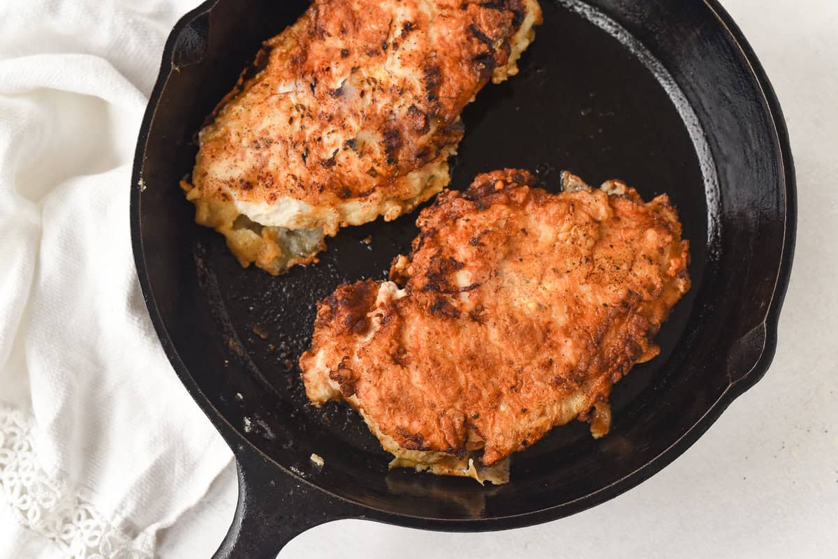 fried buttermilk chicken in a cast iron pan