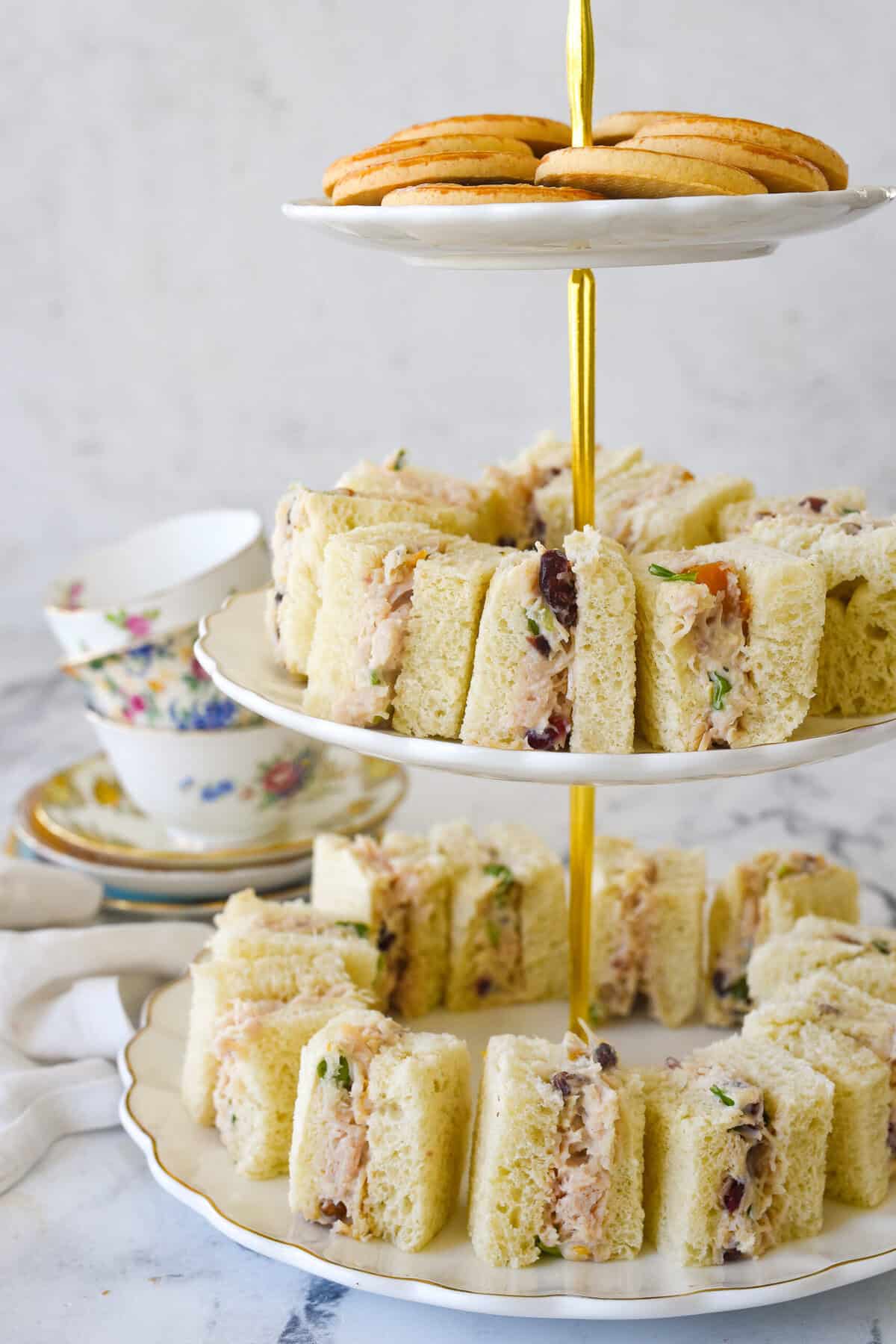 chicken salad tea sandwiches on a tiered plate