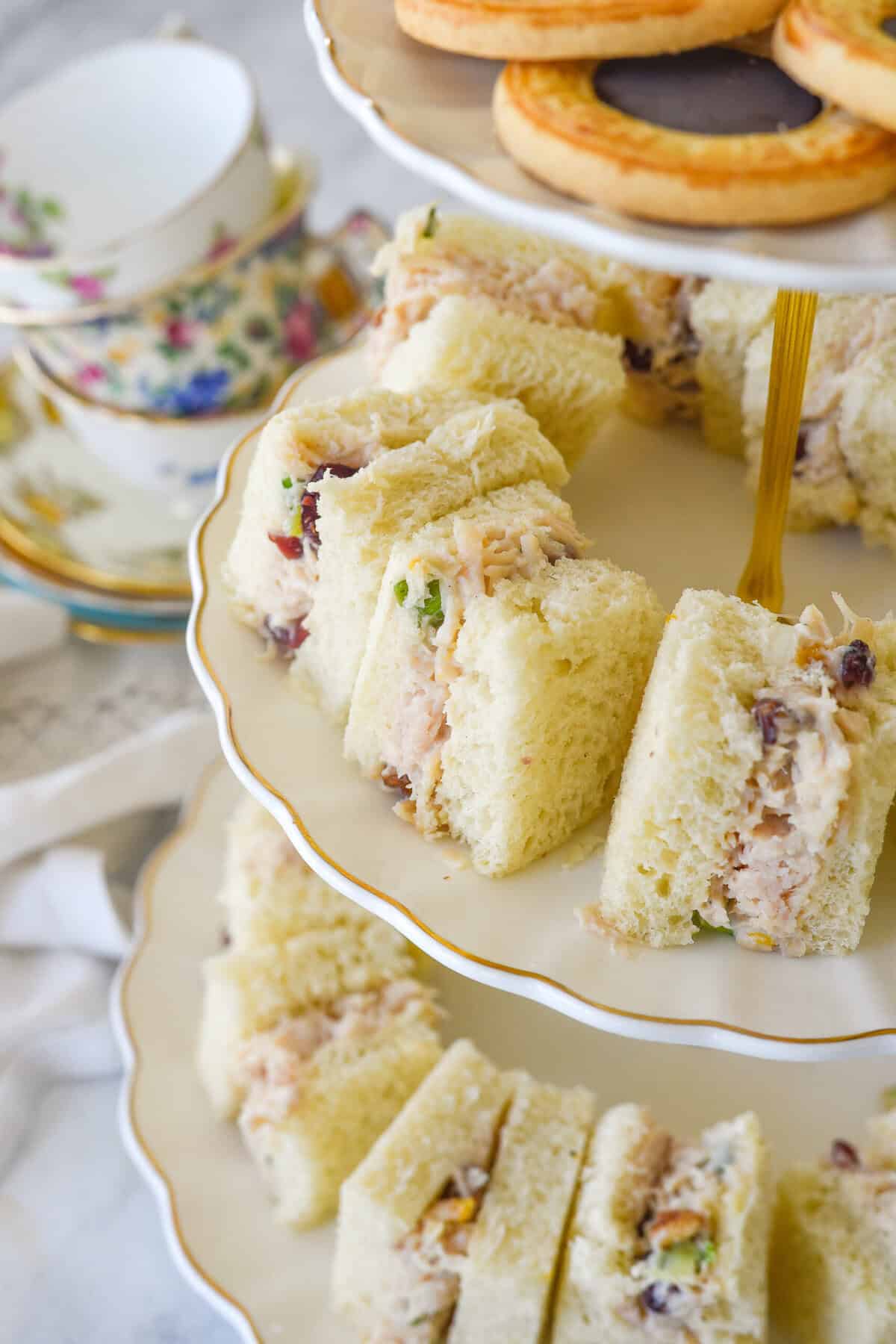 chicken salad tea sandwiches on a tray