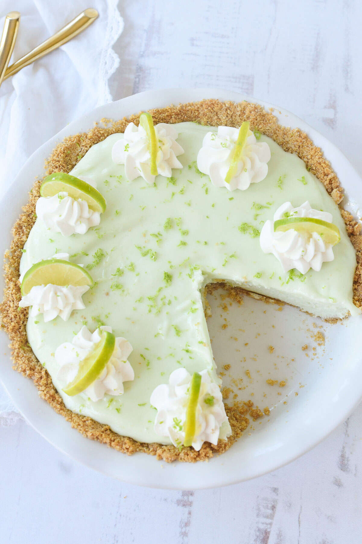 overhead shot of a frozen key lime pie with a piece missing