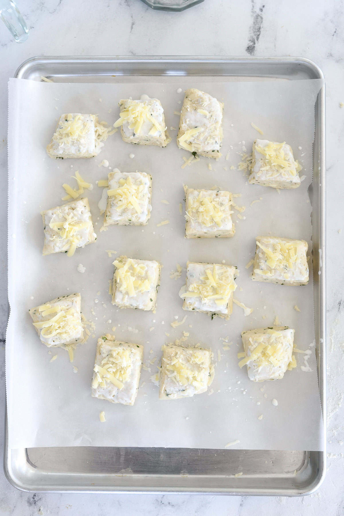 scone dough cut and on a baking sheet