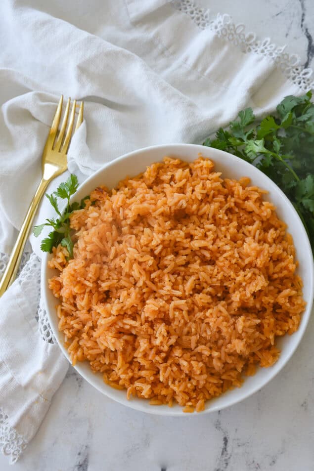 overhead sho t of white bowl full of mexican rice