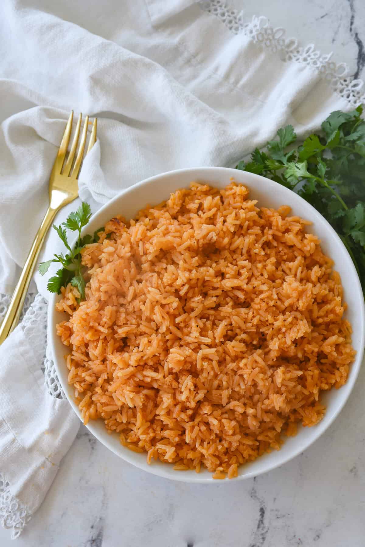overhead sho t of white bowl full of mexican rice