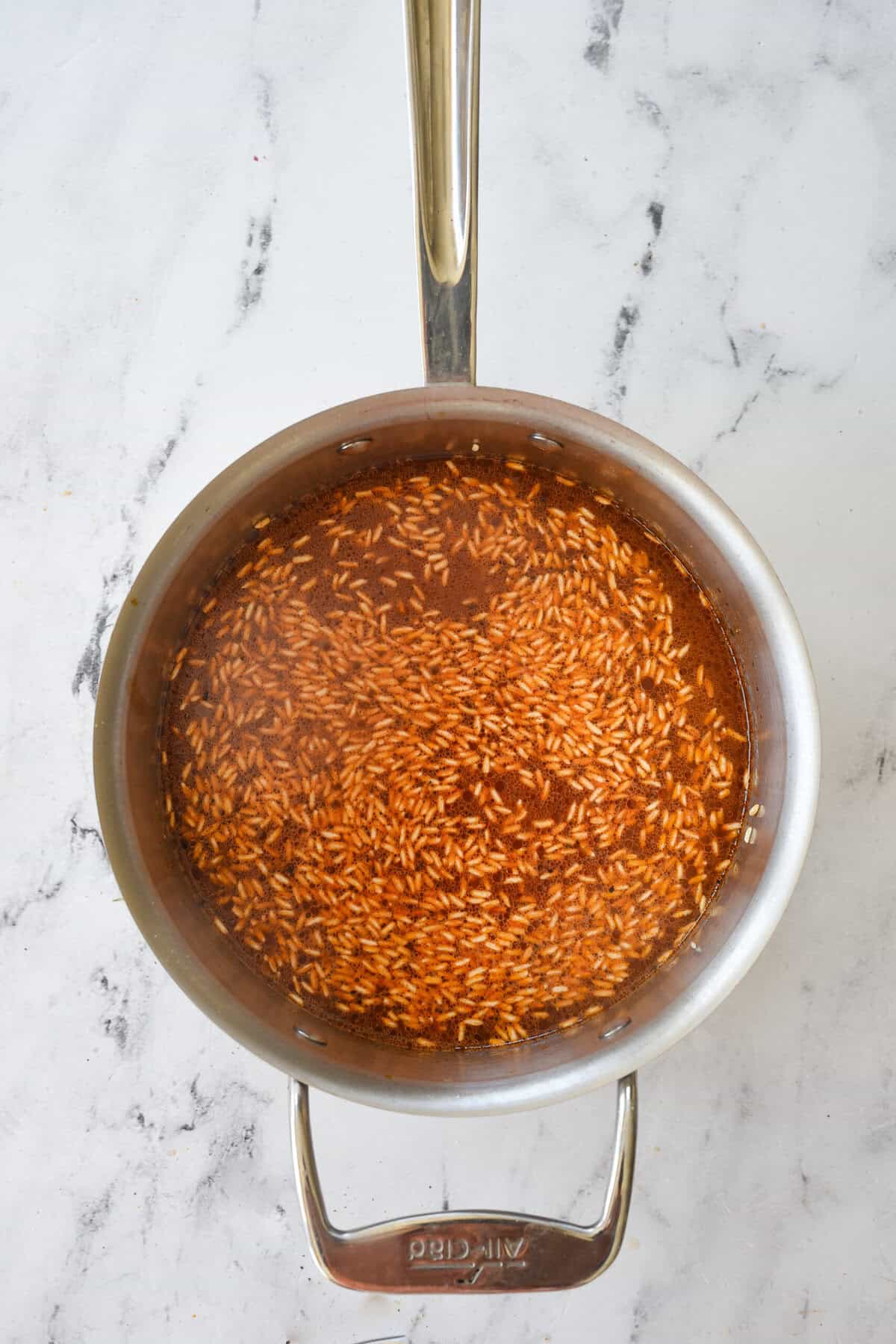 rice and broth in a sauce pan