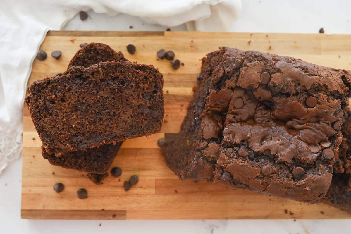 sliced chocolate zucchini bread on a cutting board
