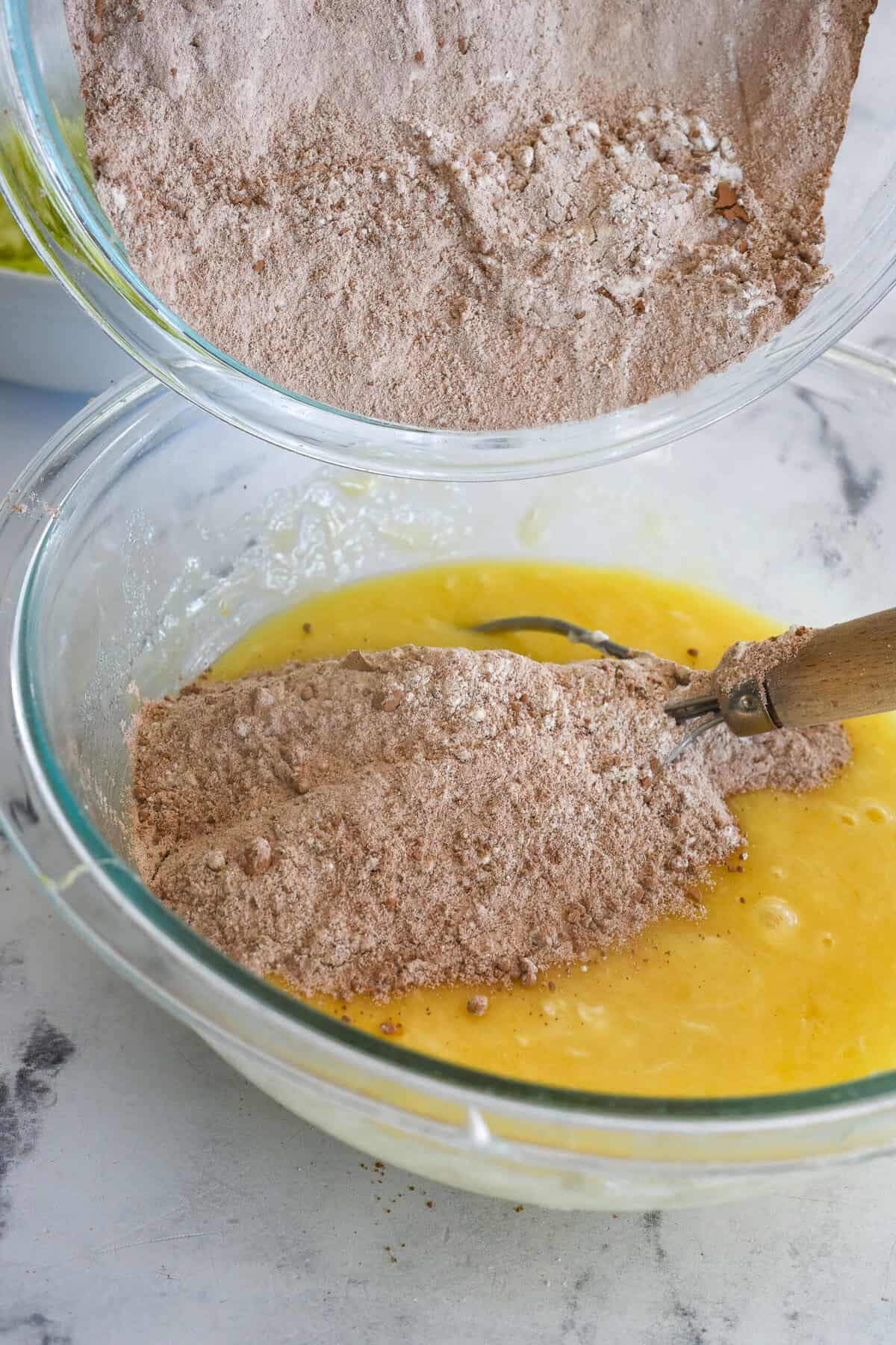 adding dry ingredients into wet ingredients