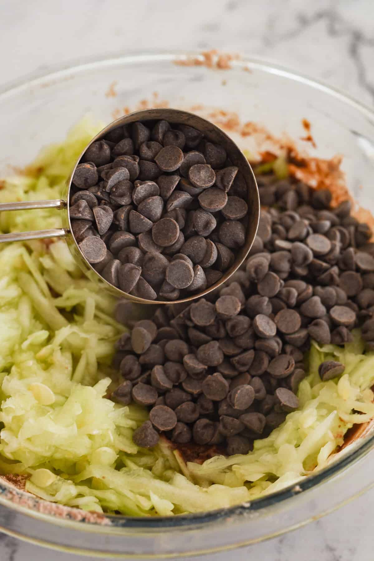 adding chocolate chips and zucchini into batter