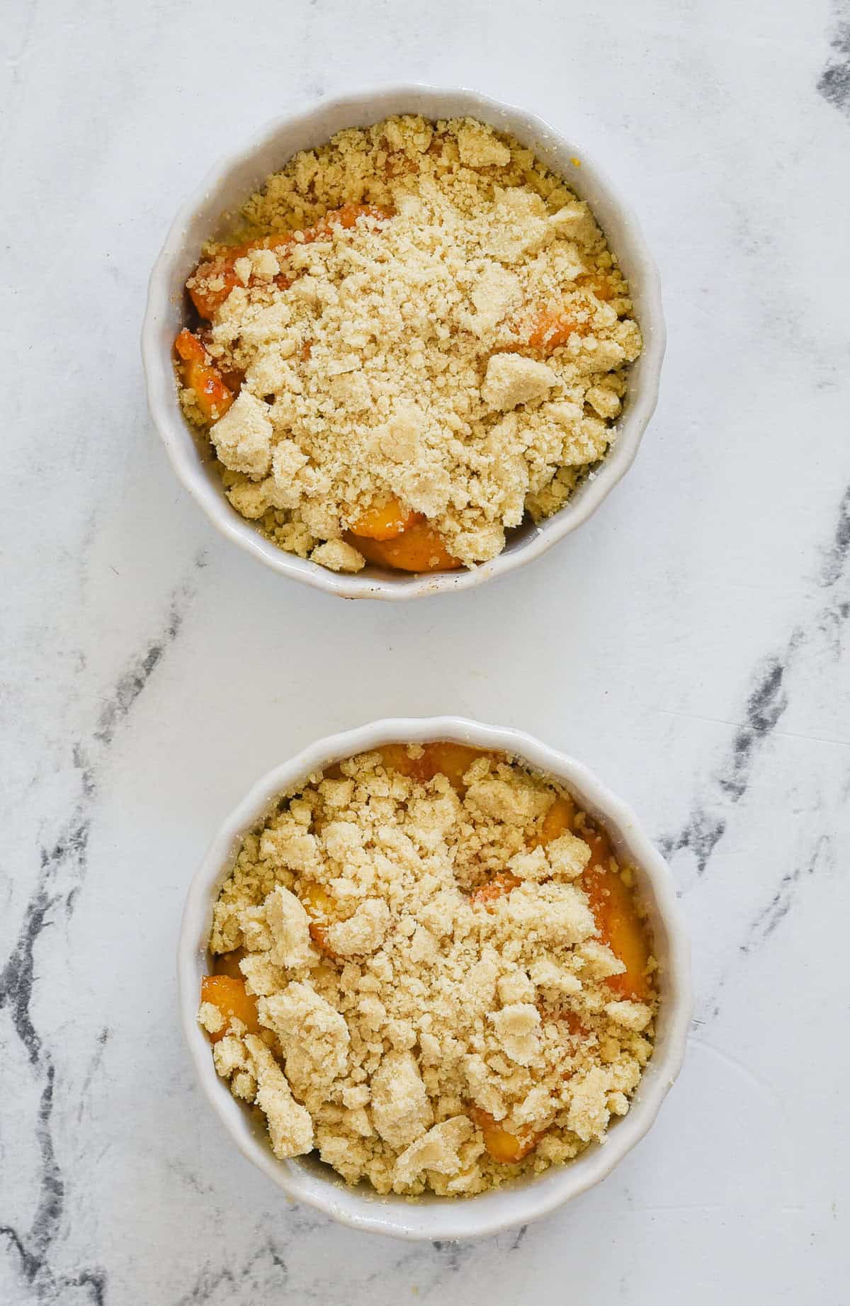 cobbler topping ontop of peaches in ramekins