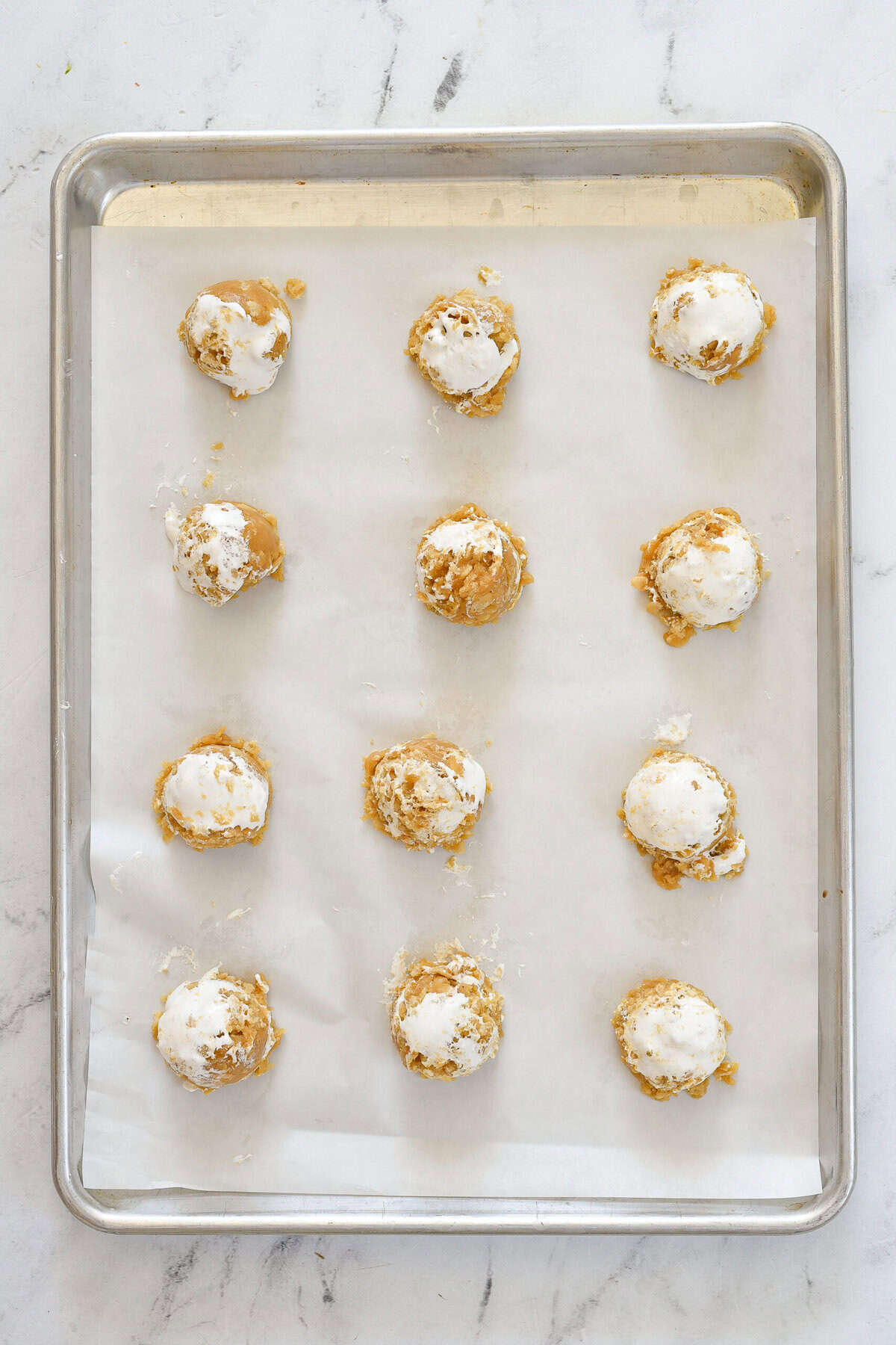 rice krispie cereal cookie dough balls on bakign sheet