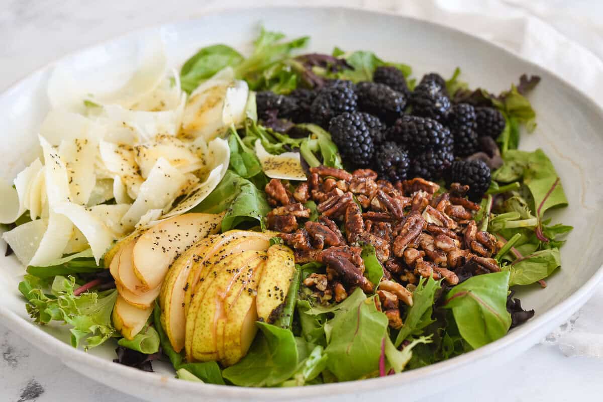 bowl with ingredients for blackberry and pear salad