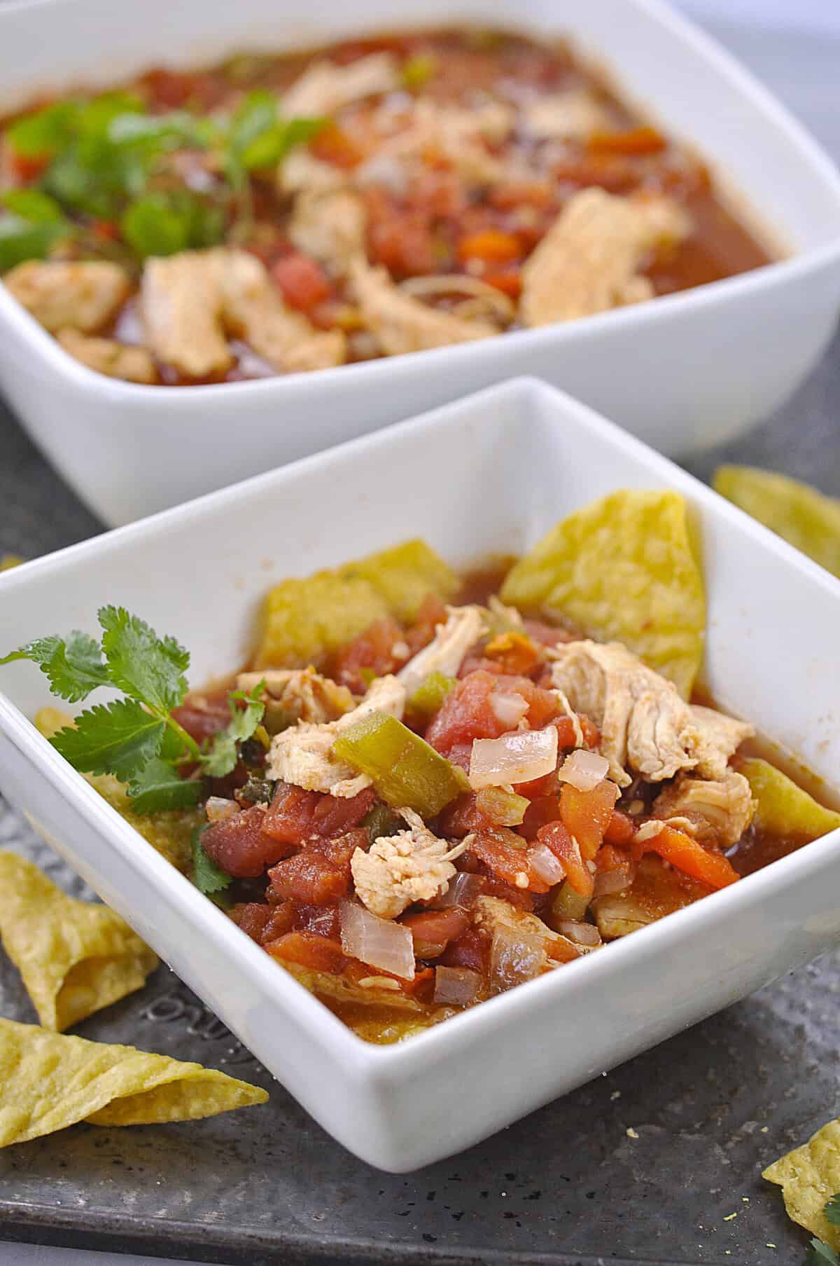 CHIPOTLE CHICKEN SOUP OVER TORTILLA CHIPS IN A BOWL