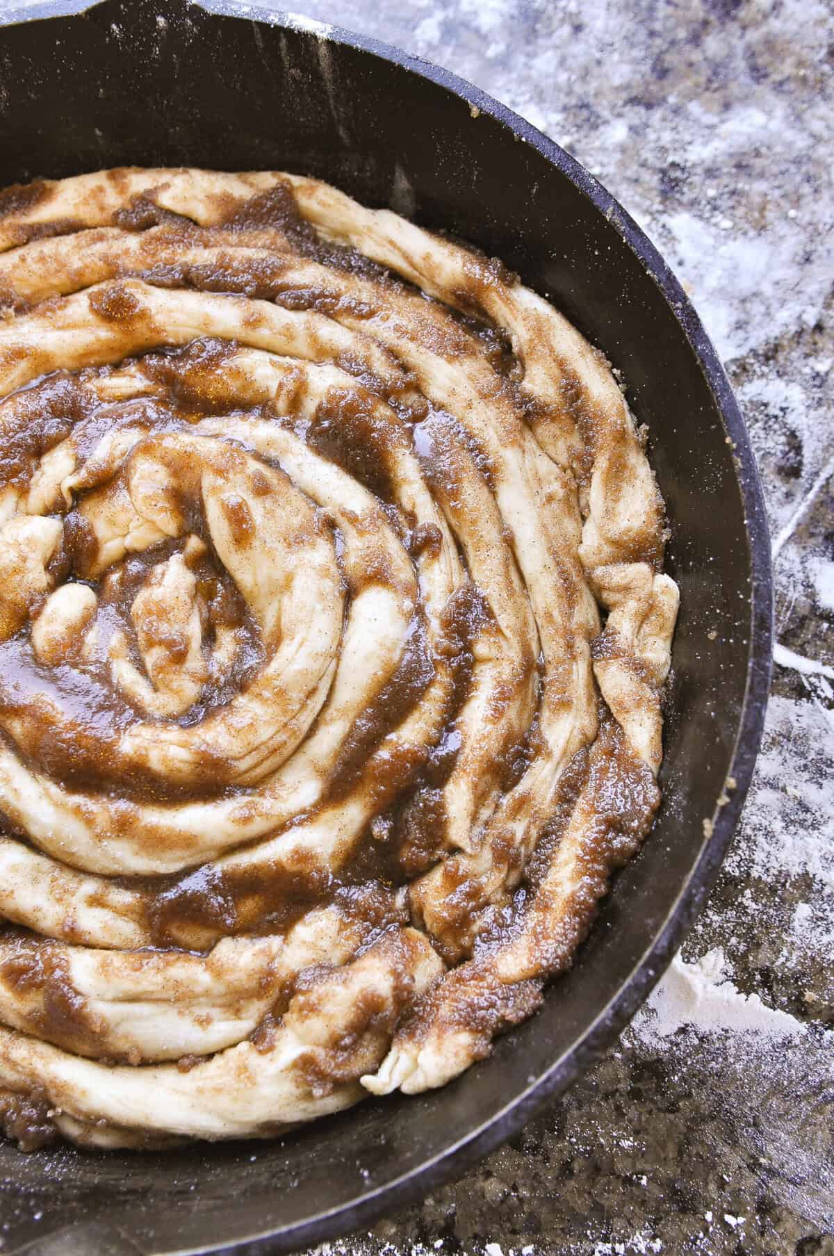 oven head view of skillet cinnamon roll ready for the oven.