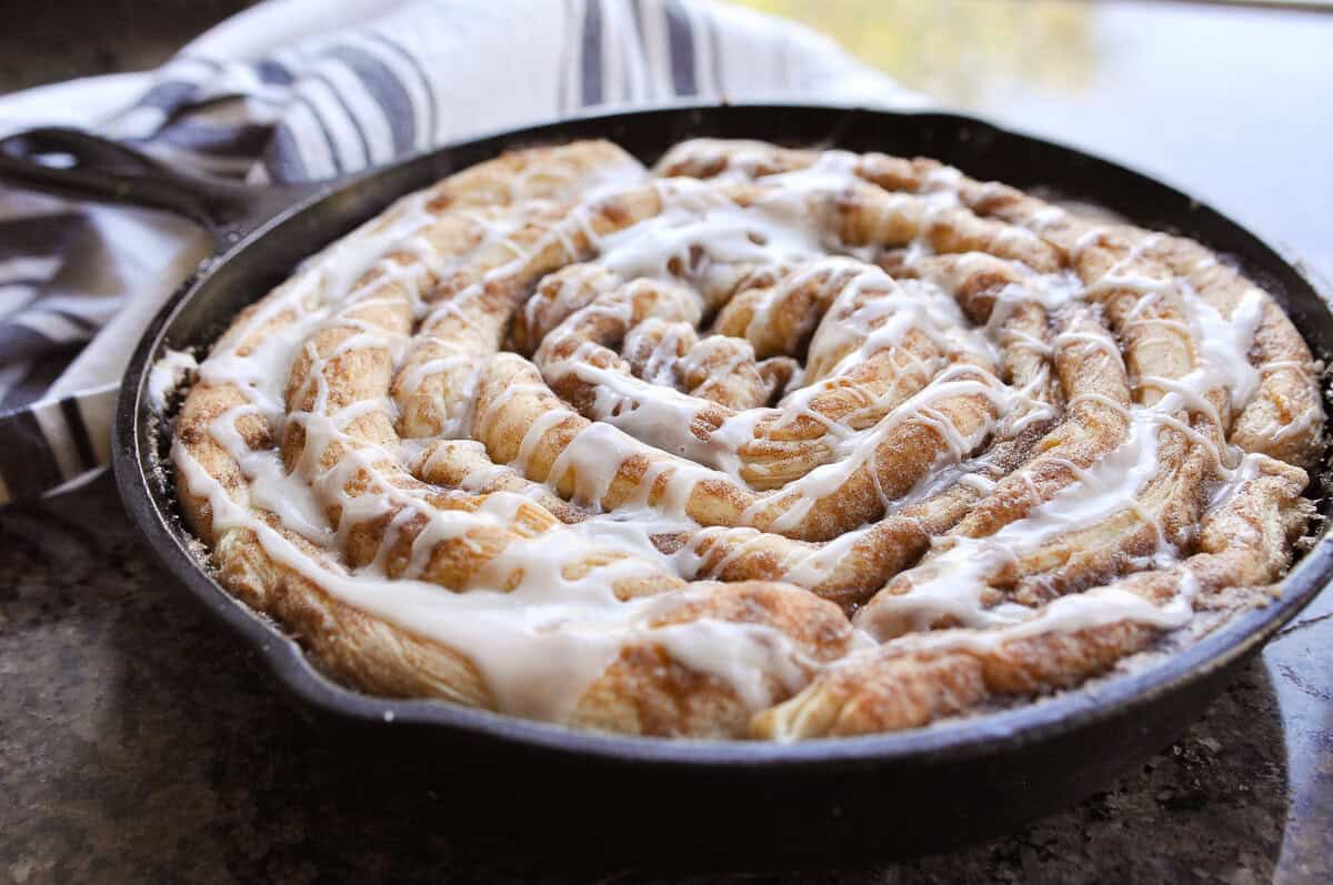 cinnamon skillet roll by a window
