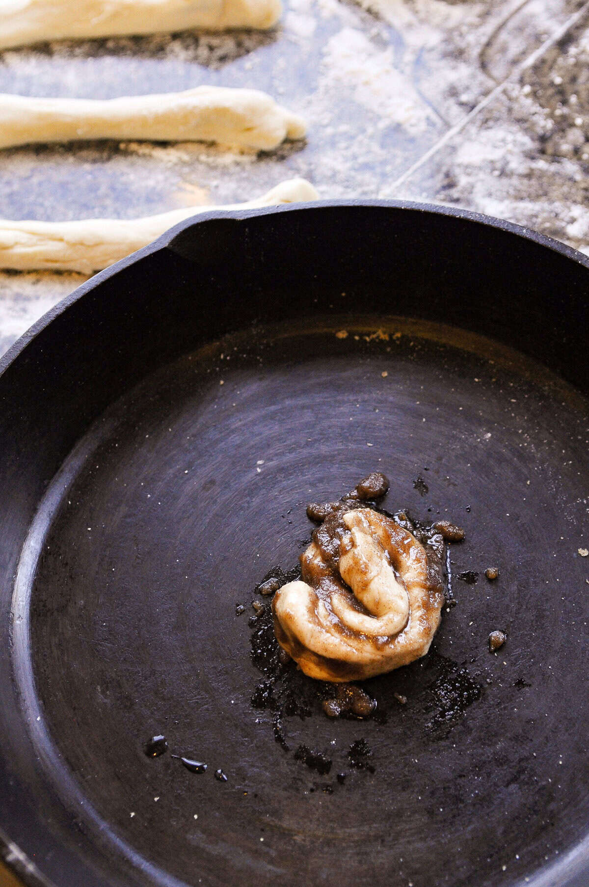 beginning of how to roll up a skillet cinnamon roll
