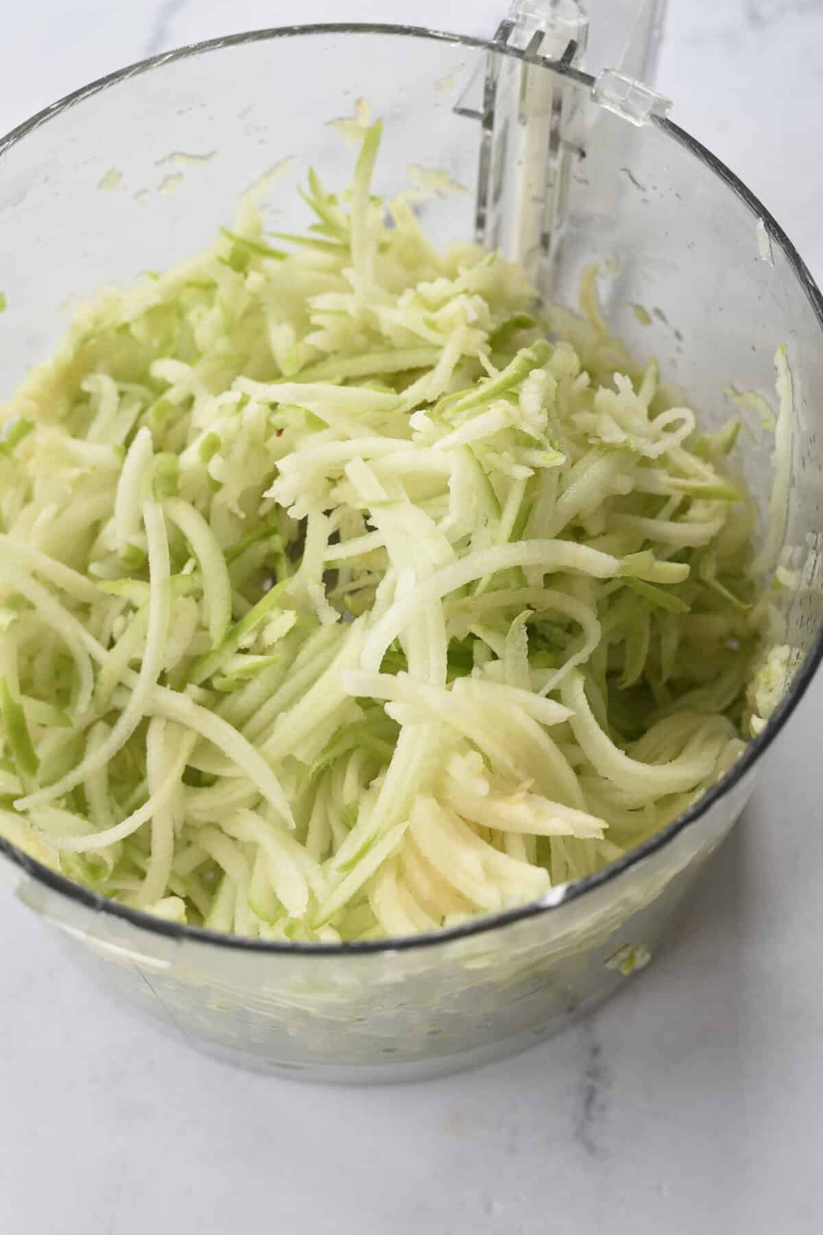 grate apples in a bowl