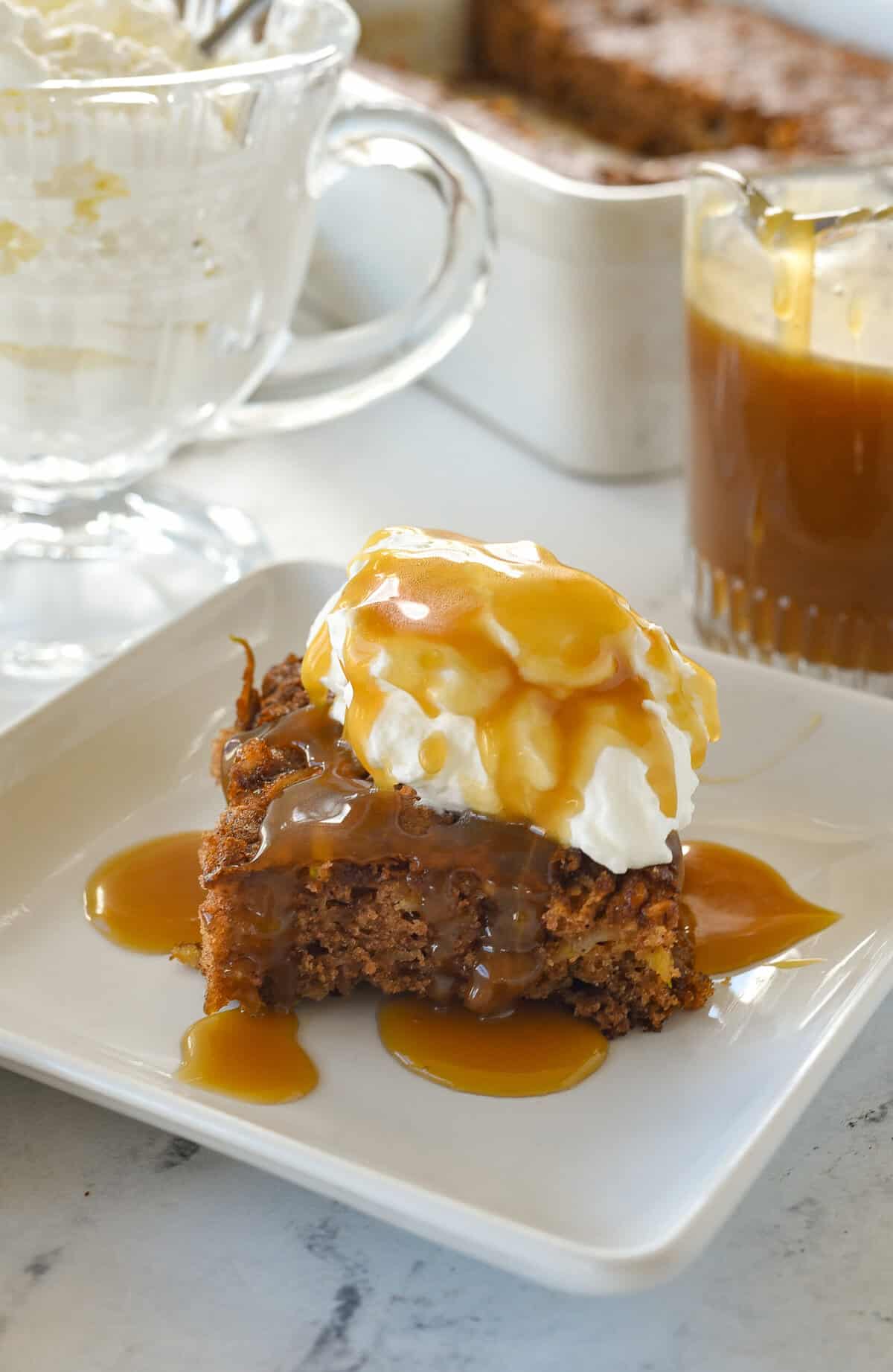 apple cake on a plate with caramel sauce on top