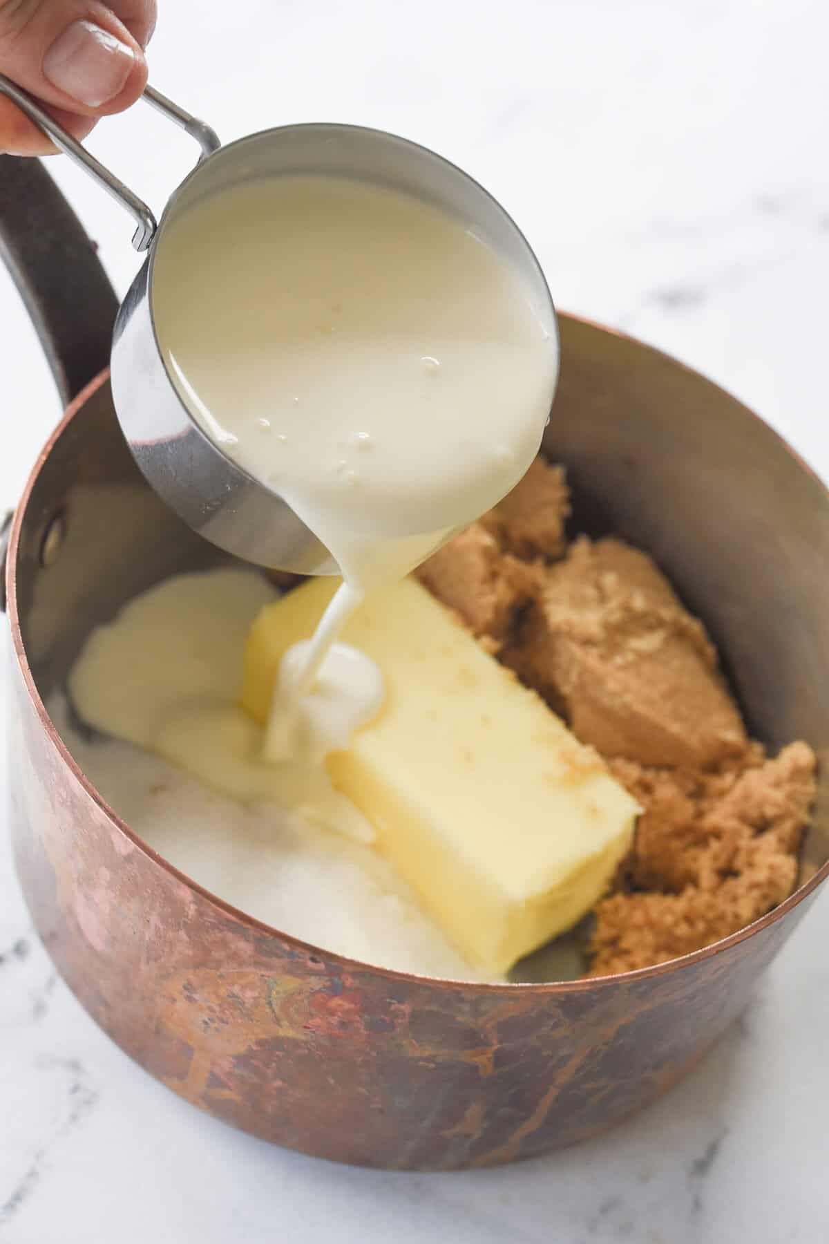 pouring cream into pan for cramale sauce

