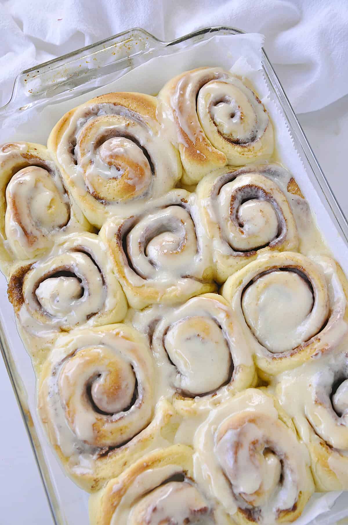overhead shot of baked and frosted overnight cinnamon rolls