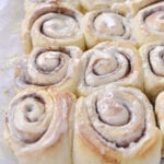 pan of cinnamon rolls on a cooling rack