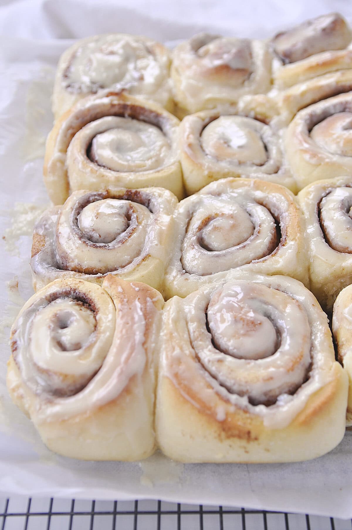 pan of cinnamon rolls on a cooling rack
