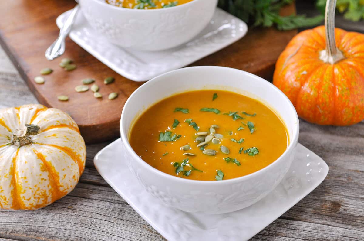 creamy pumpkin soup bowl of pumpkin curry soup with parsley on top