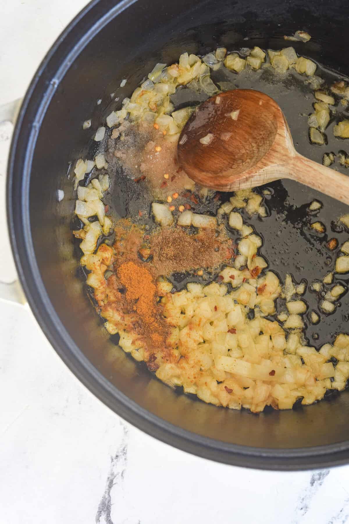 sauteeing onions and spices for pumpkin curry soup