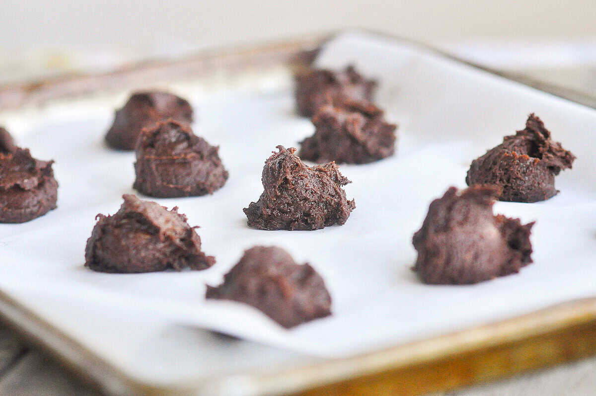 scoops of chocolate cookie dough on baking sheet