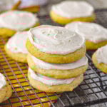 stack of frosted pumpkin sugar cookies on rack